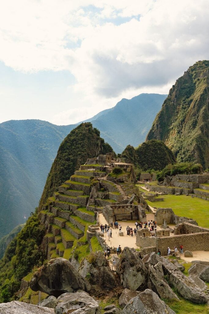 Solo Travel in Peru: A Guide From Someone Who Lives There 7 Machu Picchu with people waling around the grounds