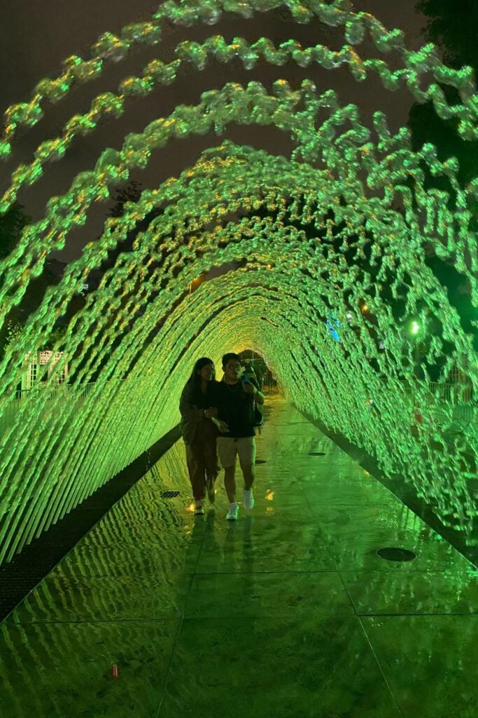 a light arch with two people walk through it
