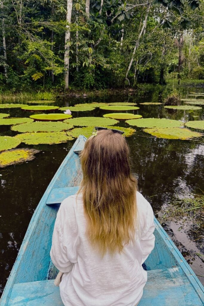 Peru Packing List: From Cusco to the Amazon 8 a girl sat on a boat in the Amazon in Peru