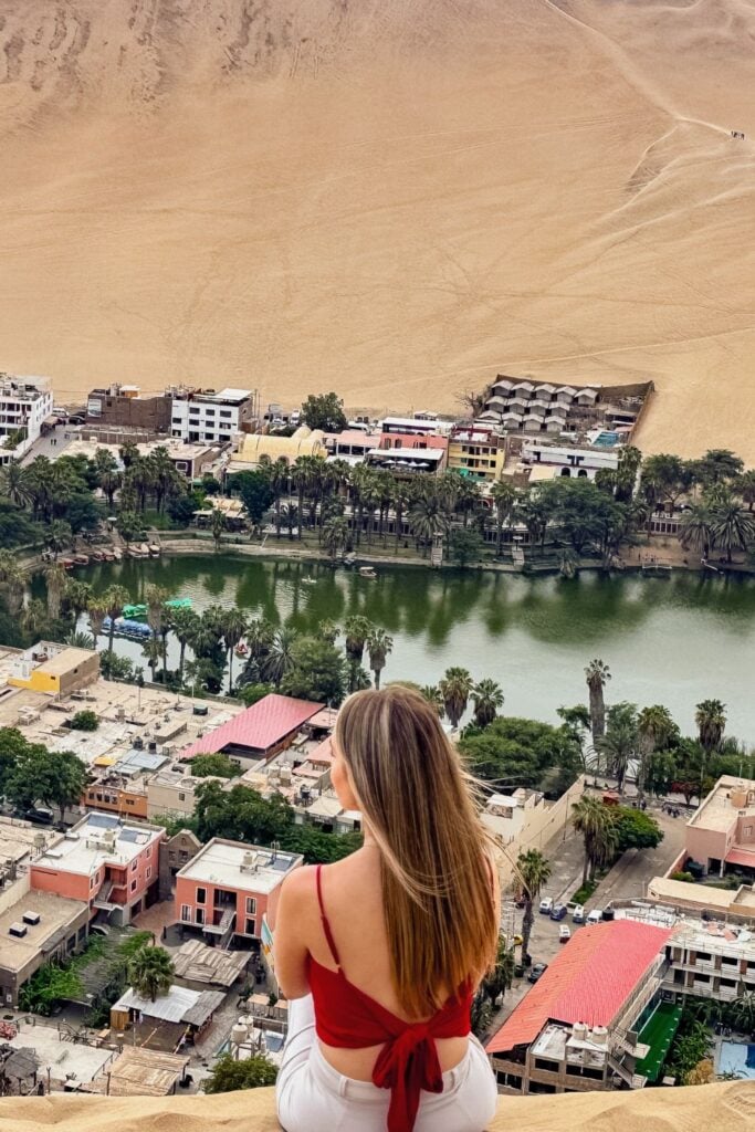 A girl looking down on Huacachina Oasis as part of this 10 Day Peru Itinerary