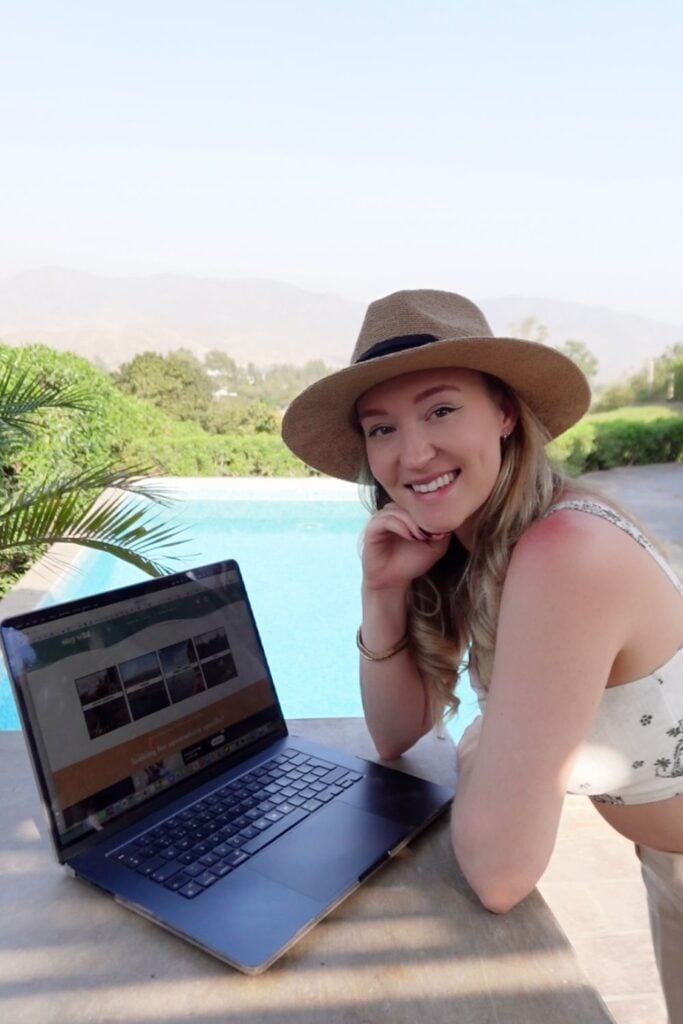digital nomad on a laptop by the pool